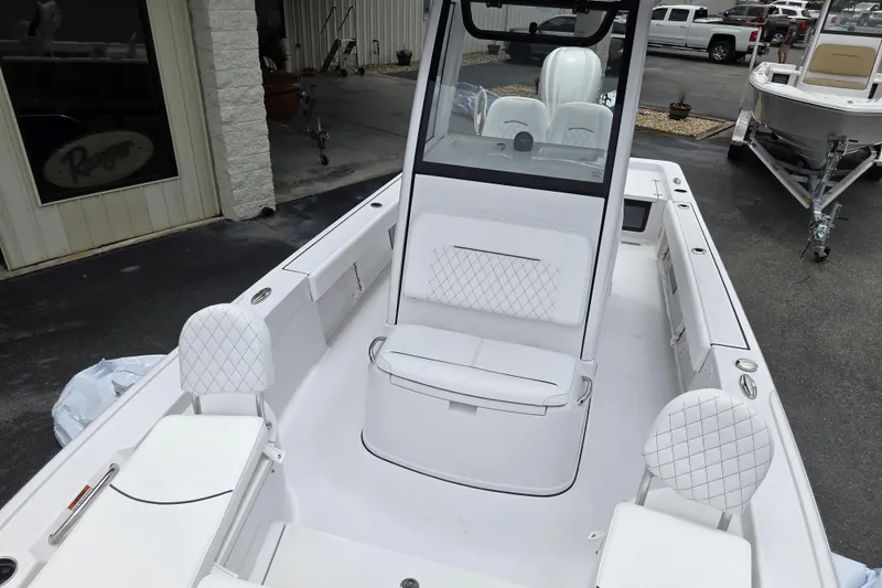 Slide: The Image of 2026 Sportsman Masters 247 Bay Boat interior with white seating and console. - 13