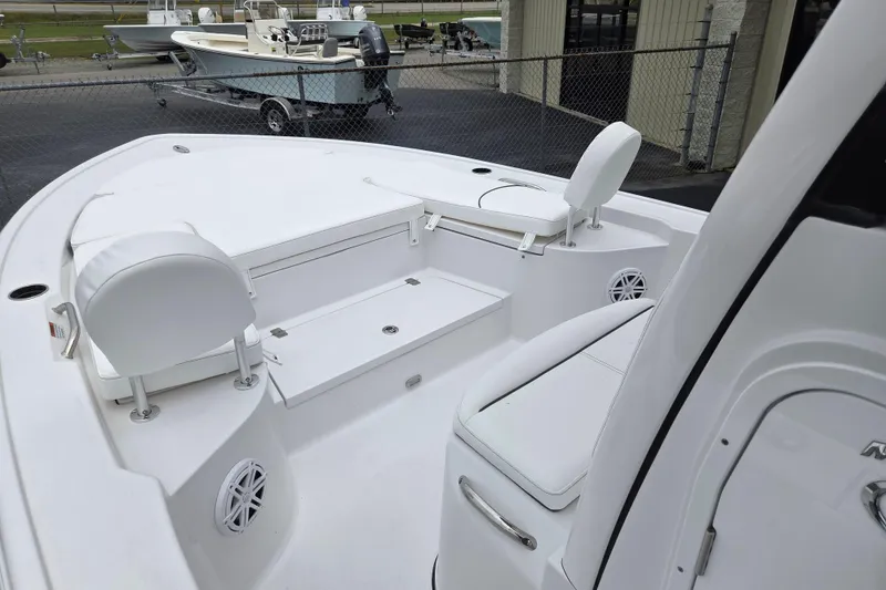 Slide: The Image of 2026 Sportsman Masters 247 Bay Boat interior with white seating and storage compartments. - 14