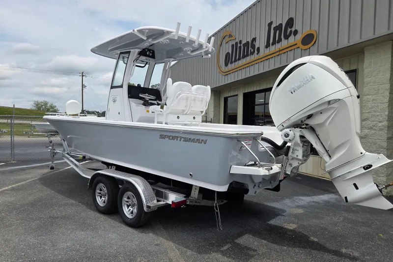 Slide: The Image of 2026 Sportsman Masters 247 Bay Boat with Yamaha engine on trailer outside dealership. - 2