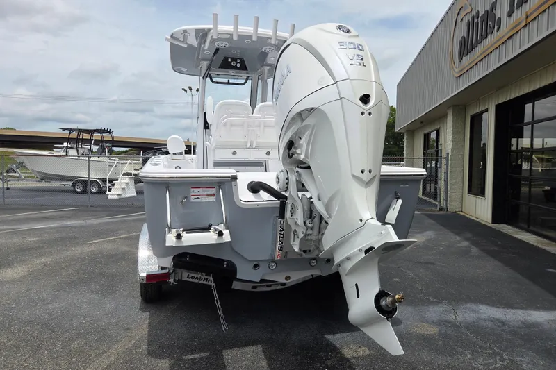Slide: The Image of 2026 Sportsman Masters 247 Bay Boat with powerful outboard motor, parked outside dealership. - 3