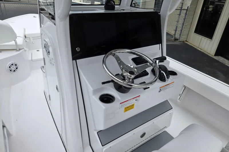 Slide: The Image of 2026 Sportsman Masters 247 Bay Boat helm with steering wheel and controls. - 7