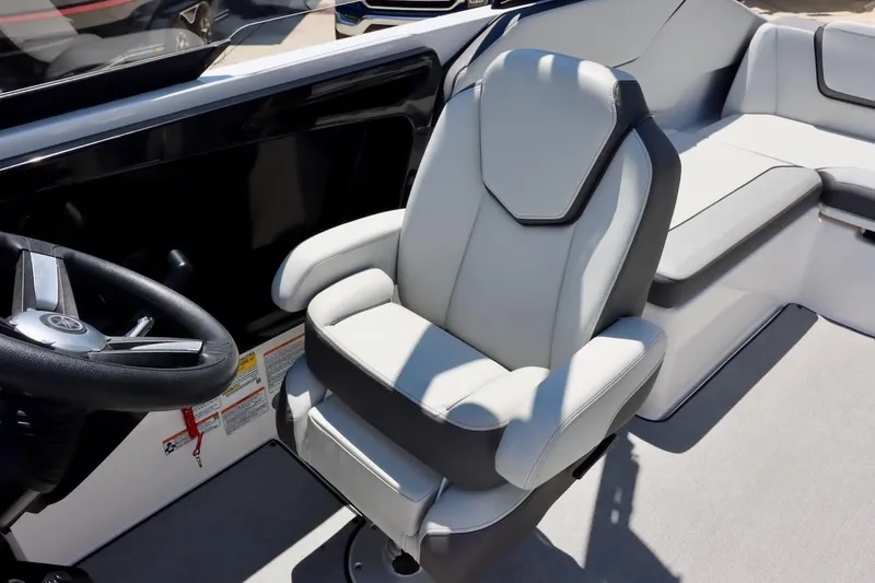 Slide: The Image of 2023 Yamaha Boats AR250 interior with steering wheel and comfortable seating. - 11