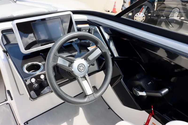 Slide: The Image of 2023 Yamaha Boats AR250 dashboard with steering wheel and touchscreen display. - 12