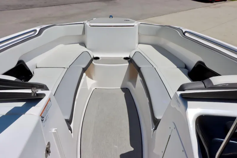 Slide: The Image of 2023 Yamaha Boats AR250 interior with spacious seating and modern design. - 17