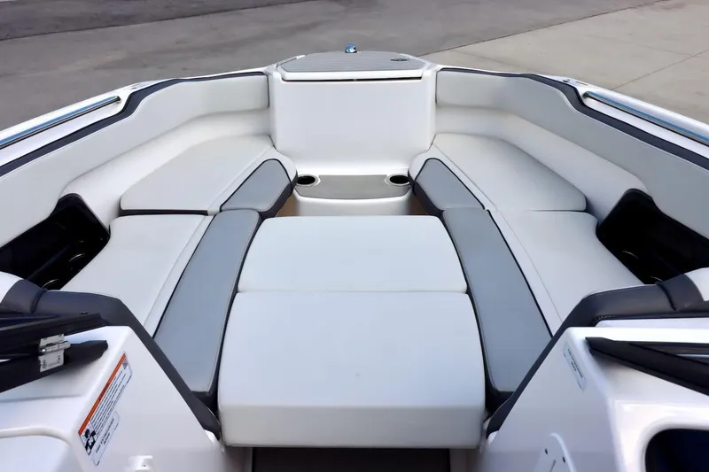 Slide: The Image of 2023 Yamaha Boats AR250 interior with spacious seating and modern design. - 18