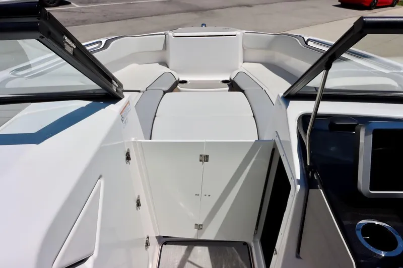 Slide: The Image of 2023 Yamaha Boats AR250 interior with open storage compartment and seating area. - 19