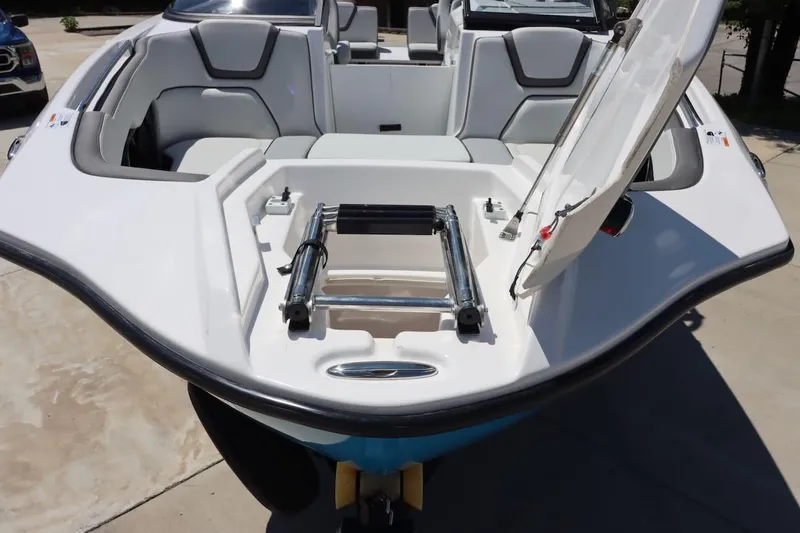 Slide: The Image of 2023 Yamaha Boats AR250 with open bow storage and seating area. - 21