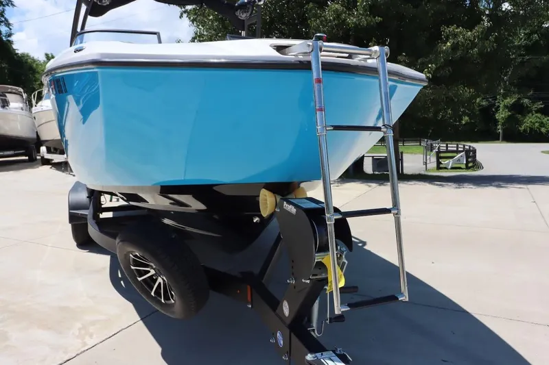 Slide: The Image of 2023 Yamaha Boats AR250 on trailer, featuring a sleek blue hull and ladder. - 23