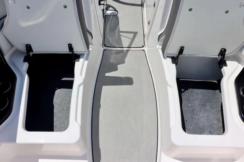 Slide: The Image of 2023 Yamaha AR250 boat interior storage compartments with open hatches. - 27