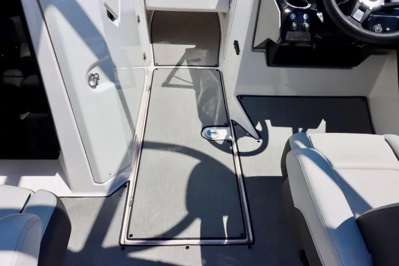Slide: The Image of 2023 Yamaha Boats AR250 interior with sleek seating and modern dashboard design. - 28