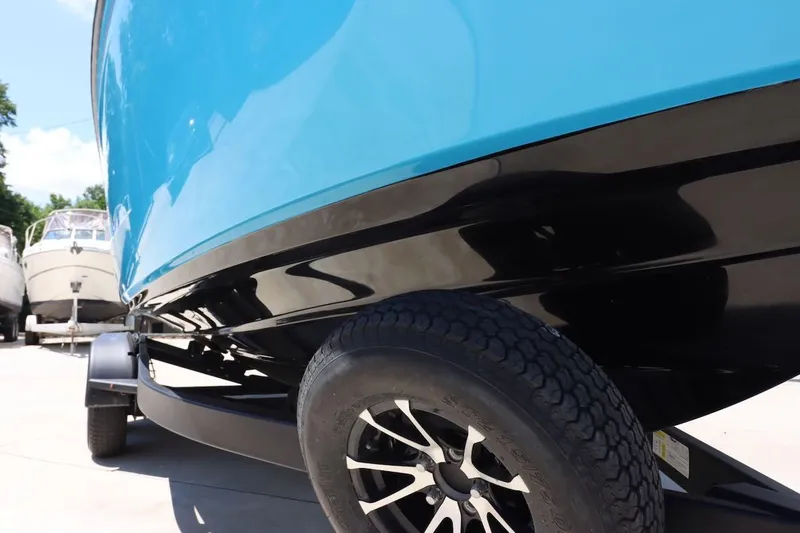 Slide: The Image of 2023 Yamaha Boats AR250 on trailer, showcasing sleek blue and black hull design. - 31
