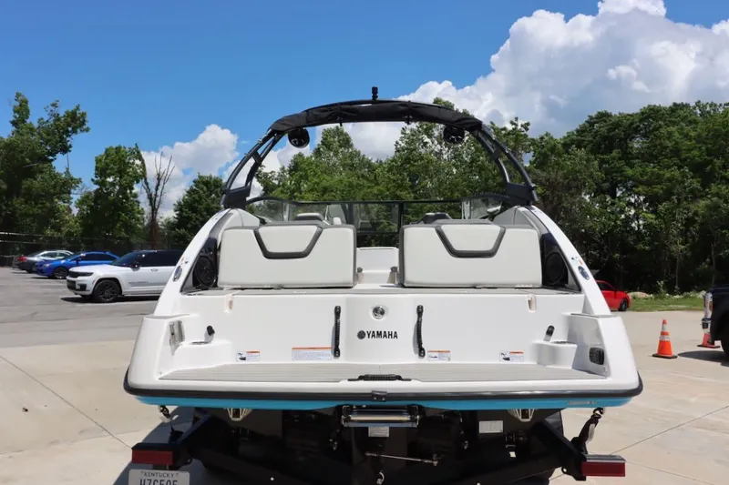 Slide: The Image of 2023 Yamaha AR250 boat on trailer, parked outdoors under a clear sky. - 5