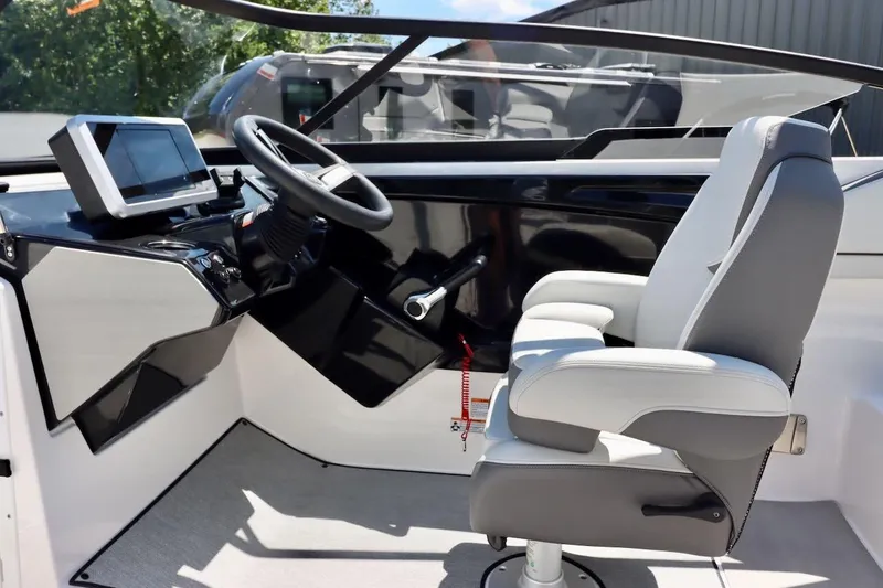 Slide: The Image of 2023 Yamaha Boats AR250 helm with steering wheel and modern dashboard display. - 9