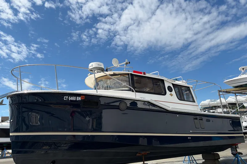 The Image of 2022 Ranger Tugs R-27 boat on display under a clear blue sky. - 0