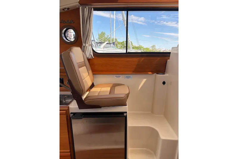 Slide: The Image of Interior of 2022 Ranger Tugs R-27 with seating and window view. - 4