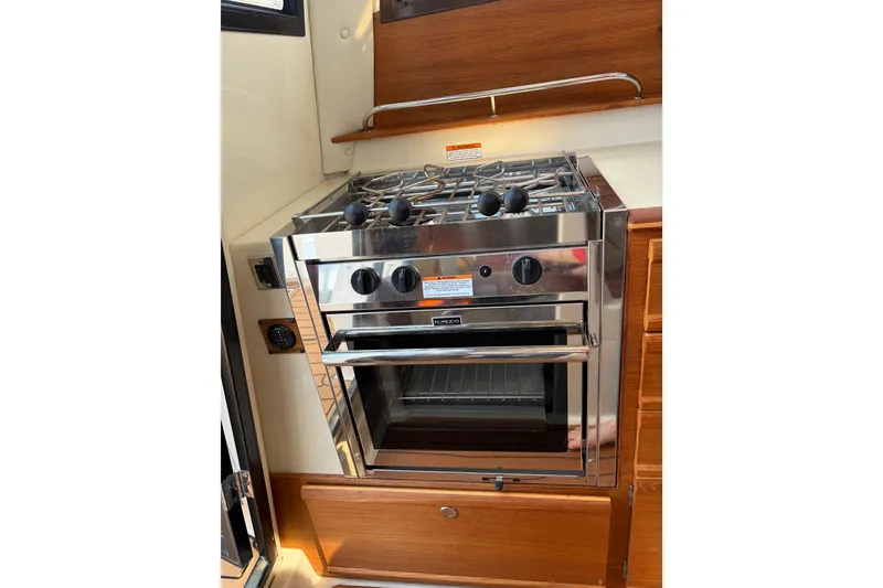 Slide: The Image of Stainless steel stove and oven in 2022 Ranger Tugs R-27 boat interior. - 6