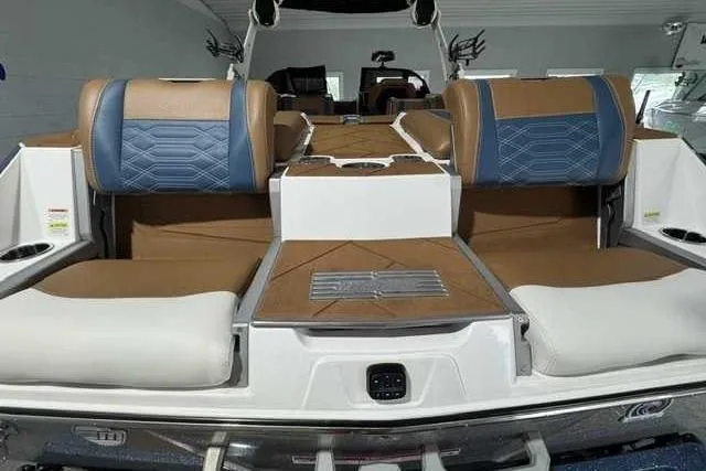 Slide: The Image of 2023 Malibu Wakesetter 25 LSV interior with brown and blue seating, showcasing luxury design. - 10