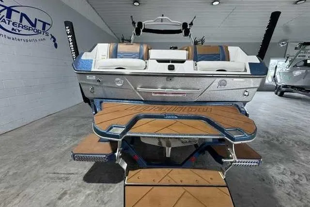 Slide: The Image of 2023 Malibu Wakesetter 25 LSV boat in showroom, rear view with teak deck. - 3
