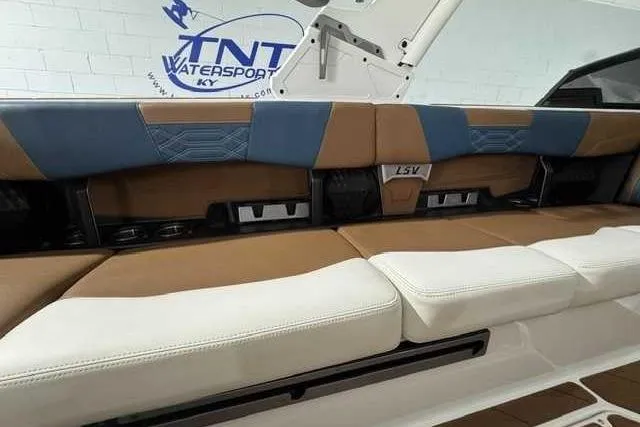 Slide: The Image of 2023 Malibu Wakesetter 25 LSV interior seating with blue and brown upholstery. - 6