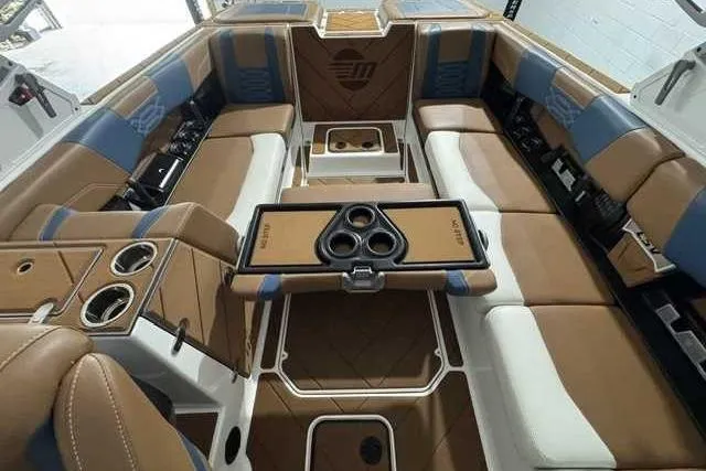 Slide: The Image of Luxurious interior of 2023 Malibu Wakesetter 25 LSV boat with tan and blue seating. - 9