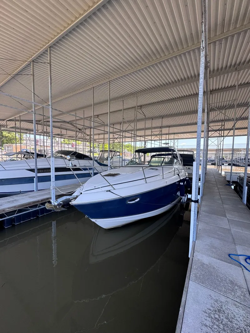 Slide: The Image of 2006 Rinker Fiesta Vee 300 boat docked in covered marina. - 13