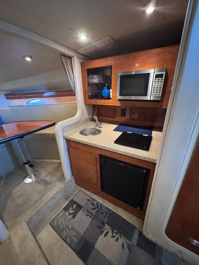 Slide: The Image of Interior of Rinker Fiesta Vee 300 yacht, kitchenette with microwave and sink. - 19