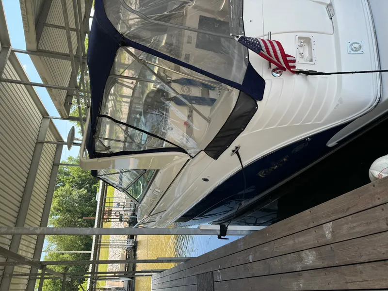 Slide: The Image of 2006 Rinker Fiesta Vee 300 boat docked with US flag. - 2