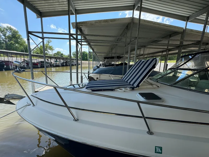 Slide: The Image of 2006 Rinker Fiesta Vee 300 boat docked with striped lounge chair. - 3