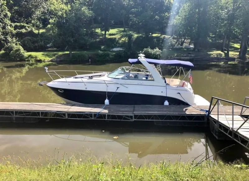 Slide: The Image of 2006 Rinker Fiesta Vee 300 docked on a sunny day. - 6