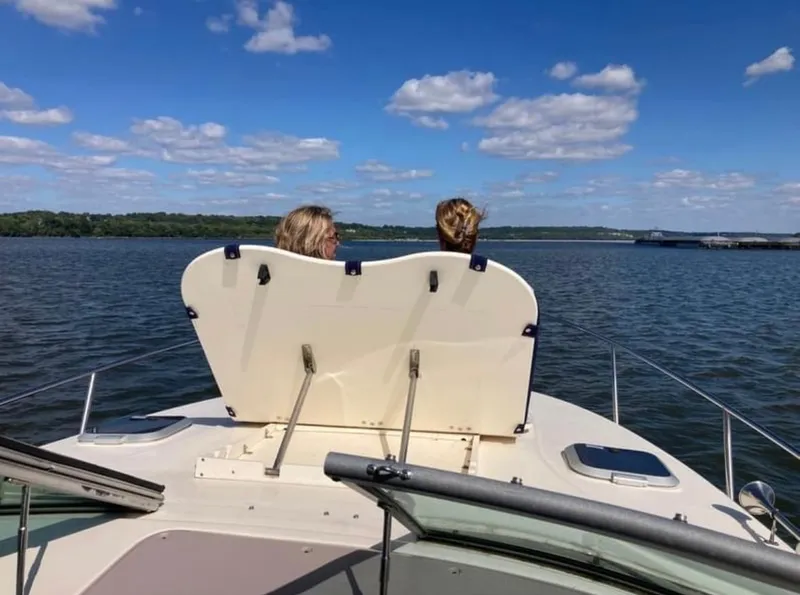 Slide: The Image of Two people on a 2006 Rinker Fiesta Vee 300 boat on the water. - 9