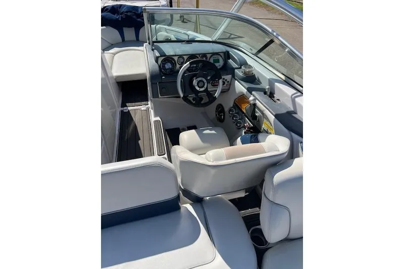 Slide: The Image of Interior of 2008 Nautique Super Air Nautique 230 boat, featuring steering wheel and dashboard controls. - 2