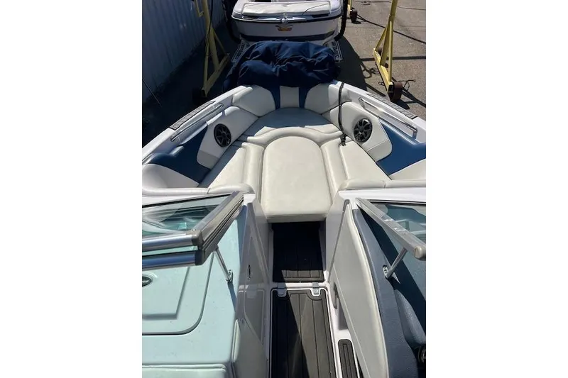 Slide: The Image of 2008 Nautique Super Air Nautique 230 boat interior with white seating and speakers. - 4