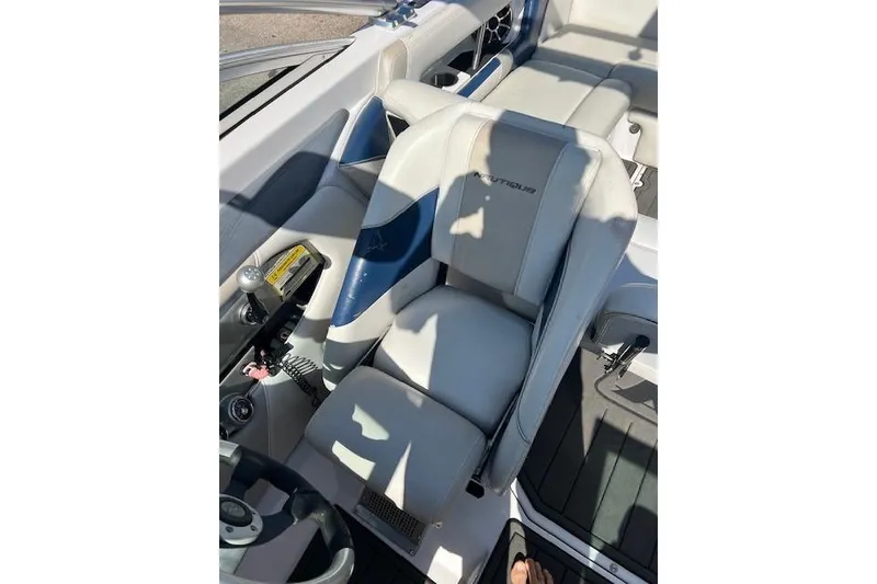 Slide: The Image of 2008 Nautique Super Air Nautique 230 boat interior with white and blue seating. - 6