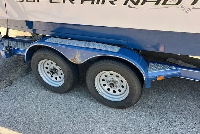 Slide: The Image of Trailer wheels of a 2008 Nautique Super Air Nautique 230 boat on pavement. - 9