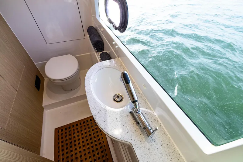 Slide: The Image of Manufacturer Provided Image: Aquila 36 Sport 2024 yacht bathroom with ocean view, modern sink, and toilet. - 14