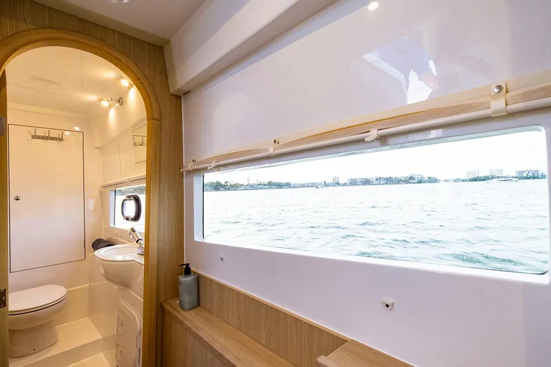 Slide: The Image of Manufacturer Provided Image: 2024 Aquila 36 Sport yacht bathroom with large window and modern fixtures. - 8