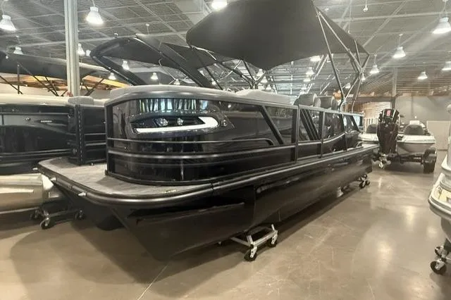 The Image of 2026 SunCatcher Elite 322SR pontoon boat displayed indoors with canopy. - 1