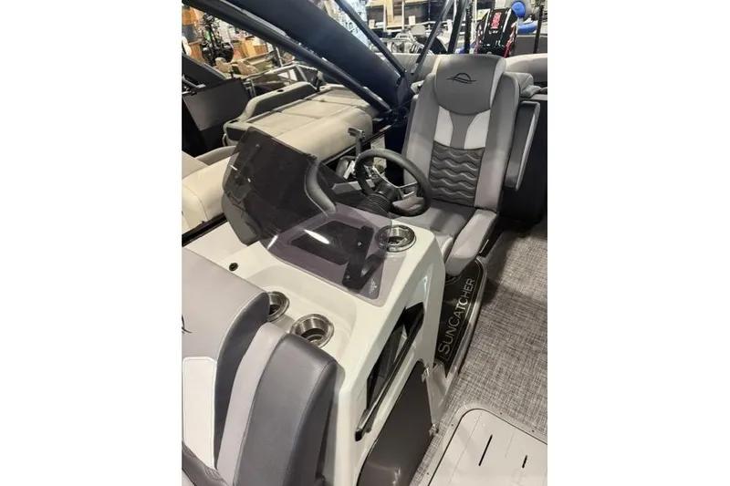 Slide: The Image of Interior of 2026 SunCatcher Elite 322SR boat with steering console and seating. - 4