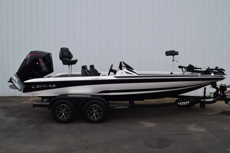 Slide: The Image of 2027 Cayams CX 20 Pro boat on trailer, side view, white and black design. - 2