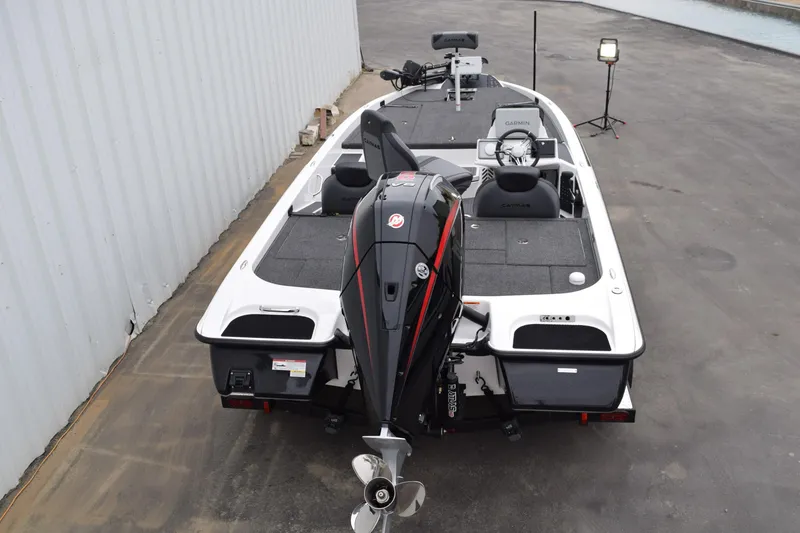 Slide: The Image of 2027 Cayams CX 20 Pro boat with powerful outboard motor, parked on concrete surface. - 25