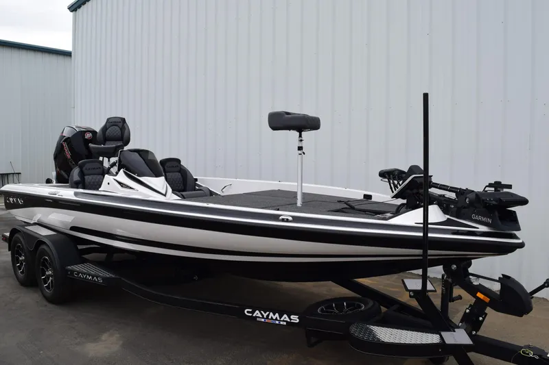 Slide: The Image of 2027 Cayams CX 20 Pro fishing boat on trailer, parked near a building. - 4