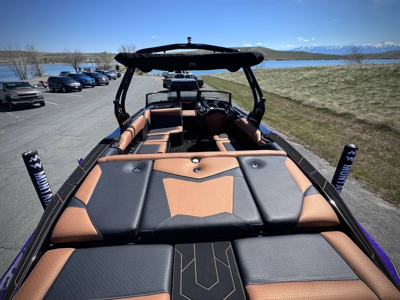 Slide: The Image of 2026 Supreme S240 boat with luxurious interior by the lakeside. - 10