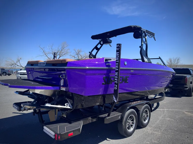 Slide: The Image of Purple 2026 Supreme S240 boat on trailer outdoors. - 6