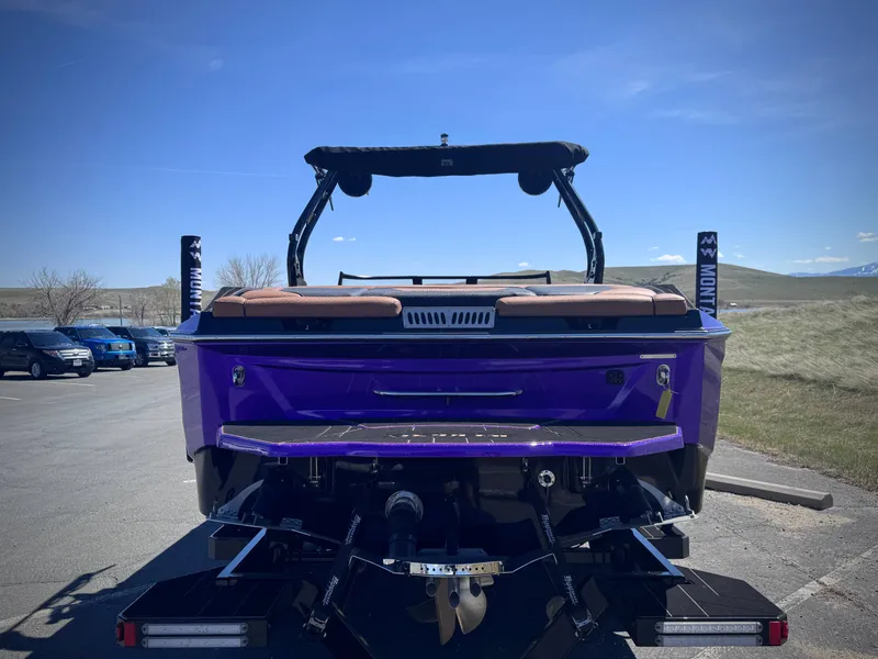 Slide: The Image of Rear view of purple Supreme S240 boat, 2026 model, in parking lot. - 8