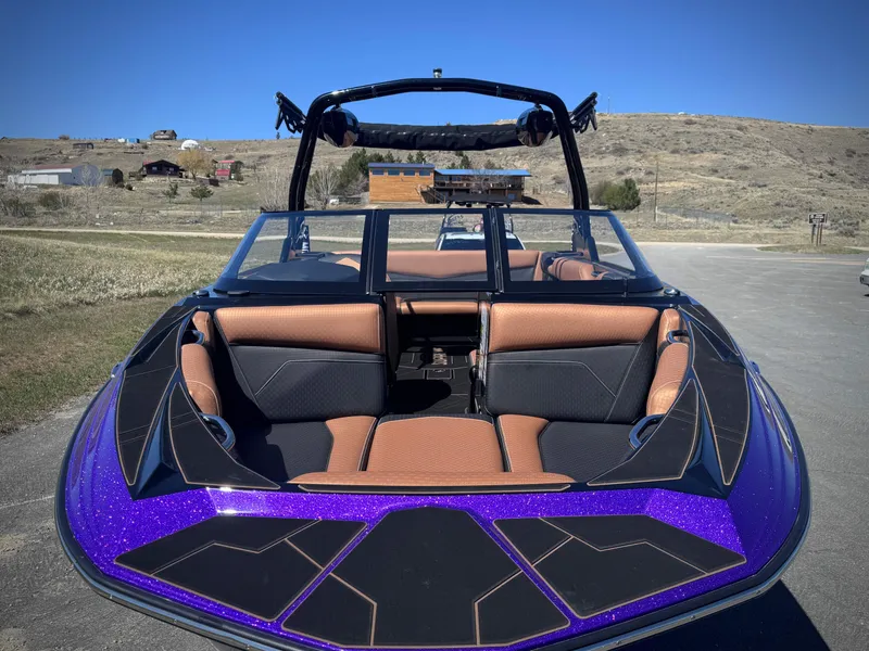 Slide: The Image of 2026 Supreme S240 boat with purple accents and brown seating. - 9