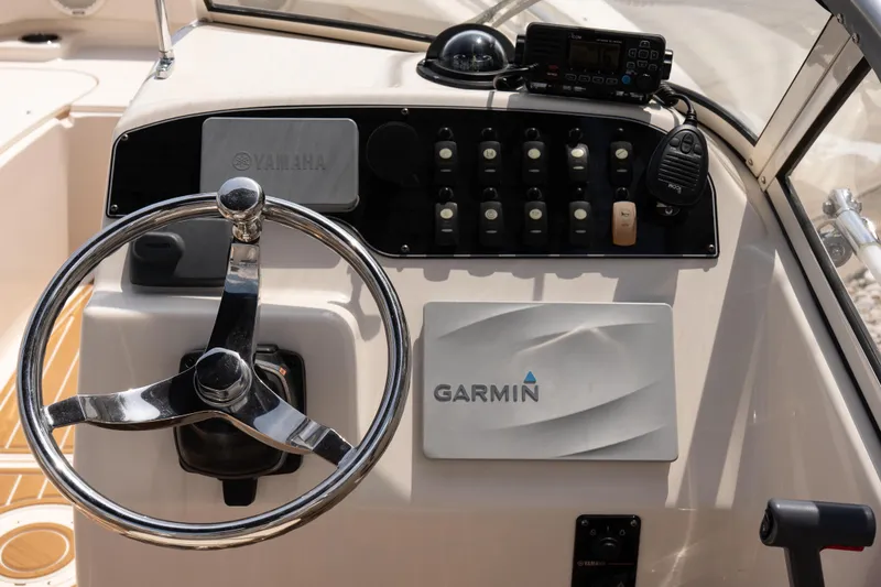 Slide: The Image of Steering console of 2017 Grady-White Freedom 205 boat with Garmin and Yamaha controls. - 11