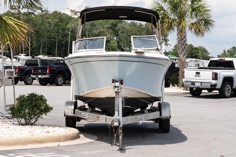 Slide: The Image of 2017 Grady-White Freedom 205 boat on trailer in parking lot with palm trees. - 3