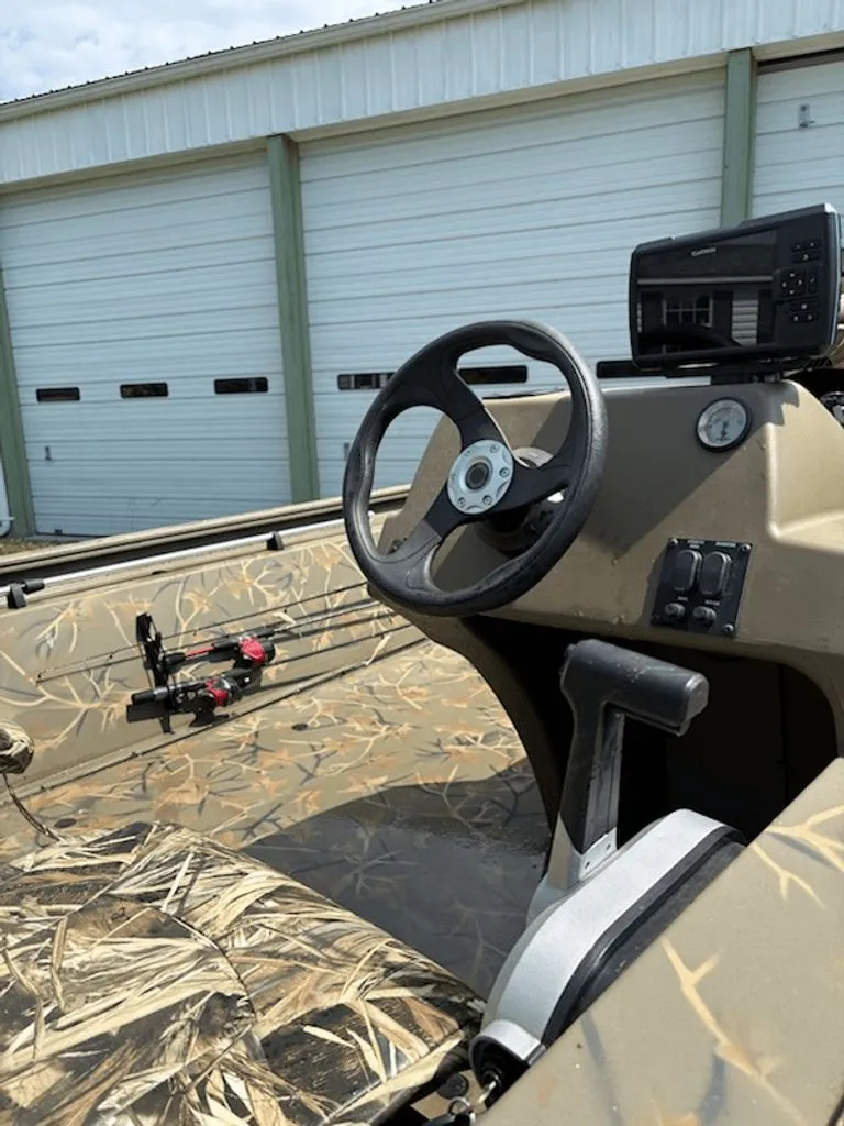 Slide: The Image of 2023 Tracker MVX 1754 boat with camouflage pattern and steering console. - 4
