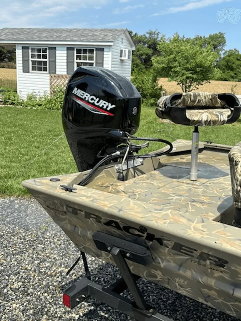 Slide: The Image of 2023 Tracker MVX 1754 boat with Mercury engine outdoors. - 5