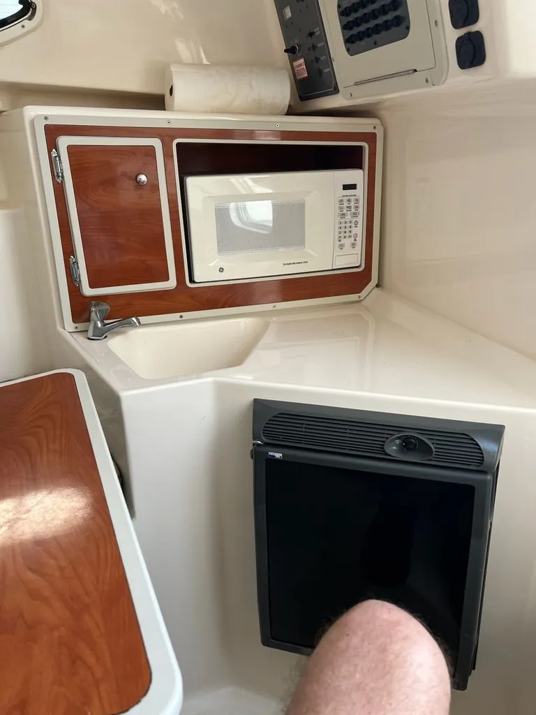 Slide: The Image of Interior of a 2008 Polar 2300 WA with microwave and fridge. - 13